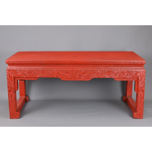 202 - A VINTAGE CHINESE CINNABAR LACQUER TYPE COFFEE-TABLE OF LOW ALTAR FORM. Carved with lozenge and flow... 