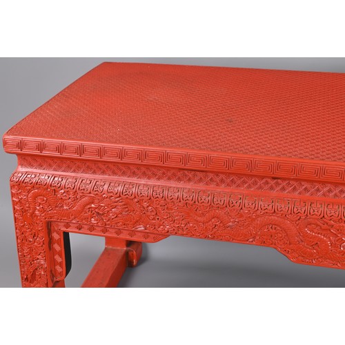 202 - A VINTAGE CHINESE CINNABAR LACQUER TYPE COFFEE-TABLE OF LOW ALTAR FORM. Carved with lozenge and flow... 