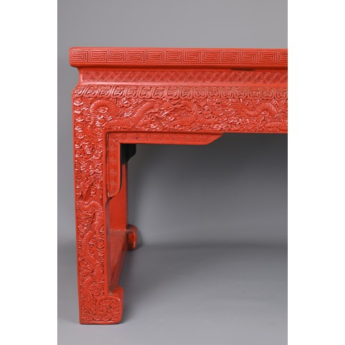 202 - A VINTAGE CHINESE CINNABAR LACQUER TYPE COFFEE-TABLE OF LOW ALTAR FORM. Carved with lozenge and flow... 