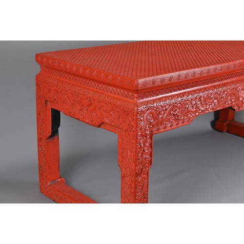 202 - A VINTAGE CHINESE CINNABAR LACQUER TYPE COFFEE-TABLE OF LOW ALTAR FORM. Carved with lozenge and flow... 