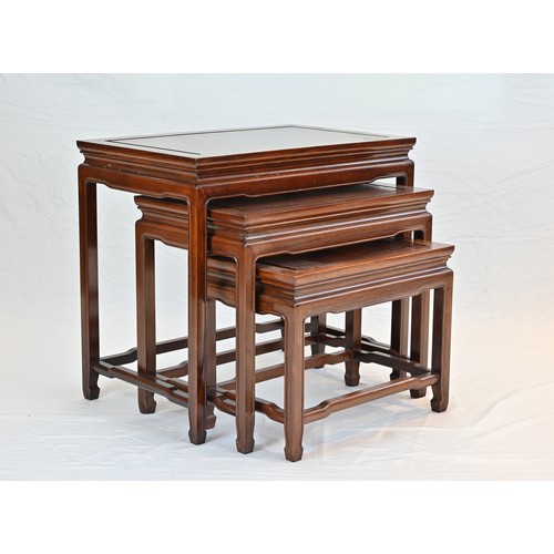 207 - A CHINESE HARDWOOD NEST OF TABLES, 20TH CENTURY. Of rectangular form with stretcher legs. Largest ta... 