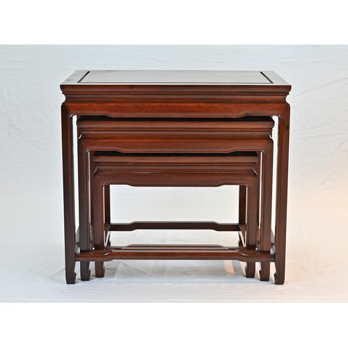 207 - A CHINESE HARDWOOD NEST OF TABLES, 20TH CENTURY. Of rectangular form with stretcher legs. Largest ta... 