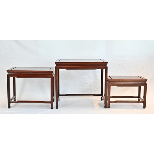 207 - A CHINESE HARDWOOD NEST OF TABLES, 20TH CENTURY. Of rectangular form with stretcher legs. Largest ta... 