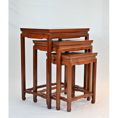 206 - A CHINESE HARDWOOD NEST OF TABLES, 20TH CENTURY. of rectangular form with stretcher legs. Largest ta... 