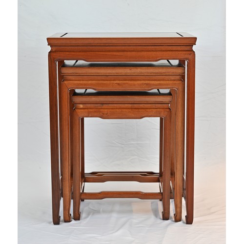 206 - A CHINESE HARDWOOD NEST OF TABLES, 20TH CENTURY. of rectangular form with stretcher legs. Largest ta... 