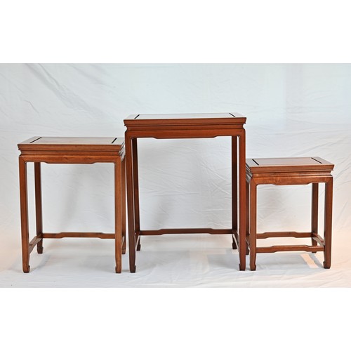 206 - A CHINESE HARDWOOD NEST OF TABLES, 20TH CENTURY. of rectangular form with stretcher legs. Largest ta... 