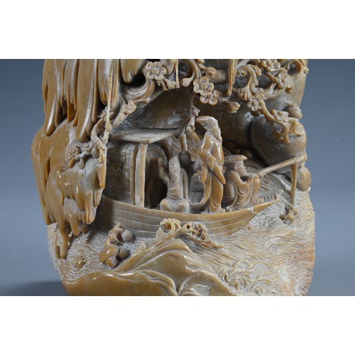 45 - A CHINESE CARVED SOAPSTONE BOULDER, 20TH CENTURY. Carved both sides in deep relief with figures on a... 