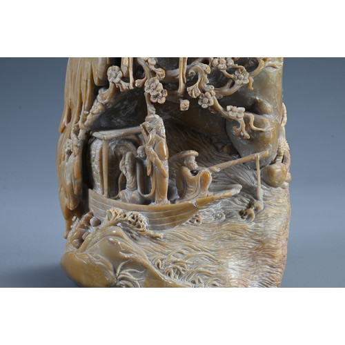 45 - A CHINESE CARVED SOAPSTONE BOULDER, 20TH CENTURY. Carved both sides in deep relief with figures on a... 