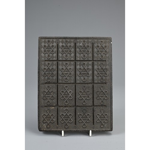 50 - A CHINESE TEA BRICK. From Yangloadong Tea Brick Factory. 23.5 x 18.5cm. Weight approx. 1KG.