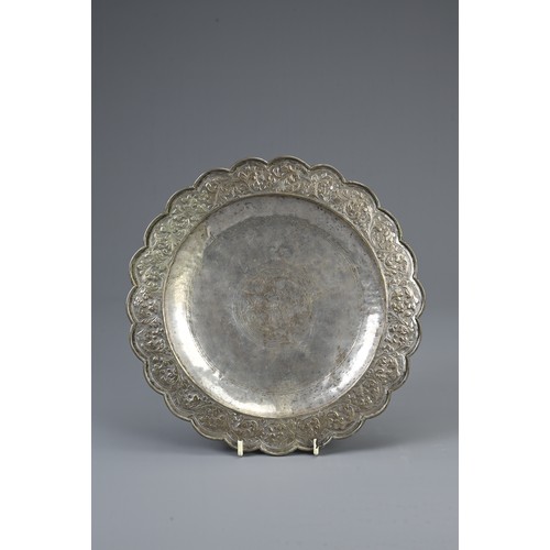 51 - A WHITE METAL PERSIAN DISH WITH CHINESE GAME COUNTERS, 19/20TH CENTURY. The lobed dish decorated wit... 