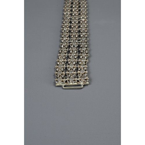 64 - A MIDDLE EASTERN METAL WARE BELT AND BUCKLES, 19/20TH CENTURY. To include a chain form belt with flo... 