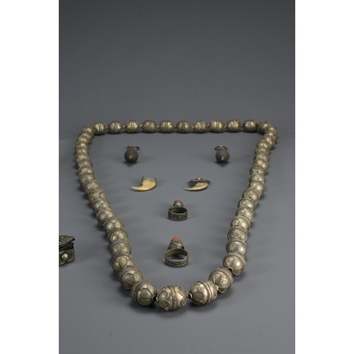 67 - A GROUP OF TURKMAN, TIBETAN, HILL TRIBE ITEMS, 20TH CENTURY. To include an ethnic metalware beaded n... 