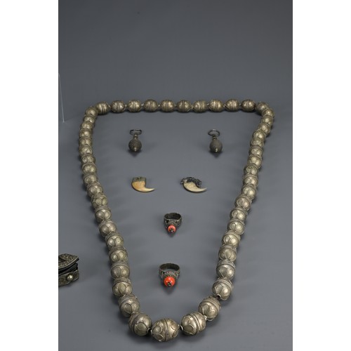 67 - A GROUP OF TURKMAN, TIBETAN, HILL TRIBE ITEMS, 20TH CENTURY. To include an ethnic metalware beaded n... 