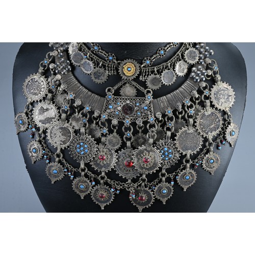 66 - A GROUP OF TRIBAL NECKLACES, 20TH CENTURY. Possibly Afghanistan, to include torque necklaces and oth... 