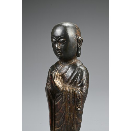 78 - A CHINESE BRONZE FIGURE OF LUOHAN. The figure dress in robes with his palms together on lotus stand.... 