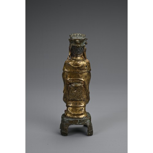 77 - A CHINESE GILT AND LACQUERED BRONZE FIGURE OF DEITY, LATE MING DYNASTY. The figure dressed in robes ... 