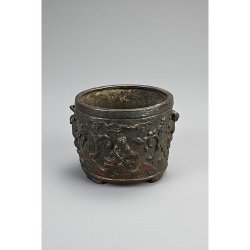 76 - A CHINESE BRONZE TRIPOD CENSER, EARLY 20TH CENTURY. Of circular form with three handles decorated in... 