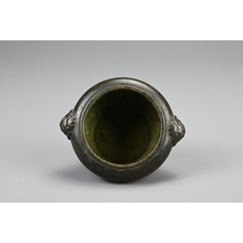 83 - A CHINESE BRONZE CENSER, 20TH CENTURY. Of circular form with twin lion mask handles and pierced cove... 