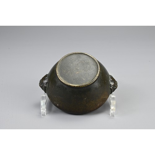 83 - A CHINESE BRONZE CENSER, 20TH CENTURY. Of circular form with twin lion mask handles and pierced cove... 