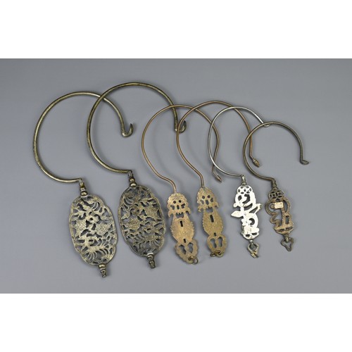 86 - A GROUP OF SIX CHINESE METALWARE BIRDCAGE HOOKS, EARLY 20TH CENTURY. With pierced sections depicting... 