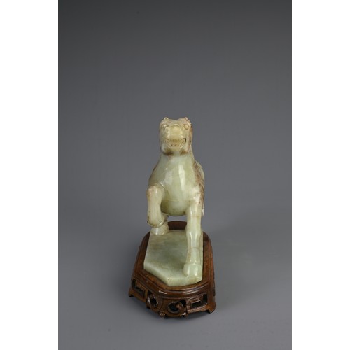 359 - A CHINESE CARVED JADE MODEL OF A PRANCING HORSE, 20TH CENTURY. Mounted on a carved and pierced woode... 