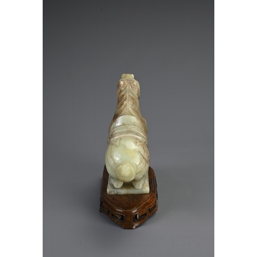 359 - A CHINESE CARVED JADE MODEL OF A PRANCING HORSE, 20TH CENTURY. Mounted on a carved and pierced woode... 