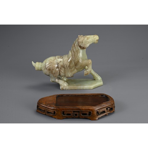 359 - A CHINESE CARVED JADE MODEL OF A PRANCING HORSE, 20TH CENTURY. Mounted on a carved and pierced woode... 