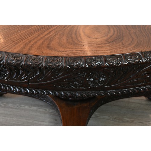 203 - A LARGE ANGLO INDIAN PADOUK CENTRE TABLE, 19TH CENTURY. Round circular top with carved floral skirt ... 