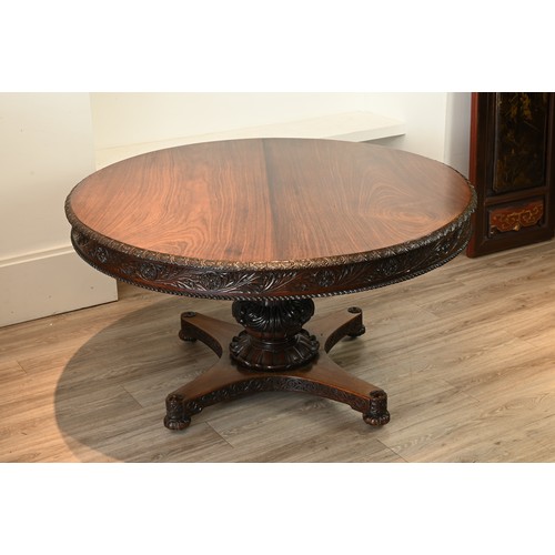 203 - A LARGE ANGLO INDIAN PADOUK CENTRE TABLE, 19TH CENTURY. Round circular top with carved floral skirt ... 