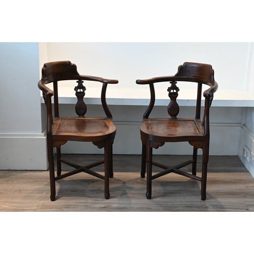 205 - A PAIR OF CHINESE HARDWOOD CORNER CHAIRS, EARLY 20TH CENTURY. A curved top rail on four legs and cro... 