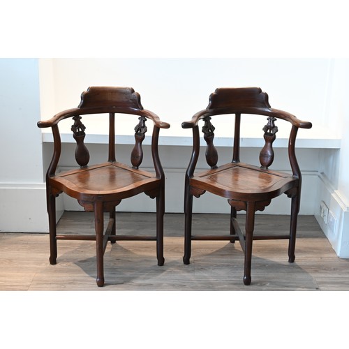 205 - A PAIR OF CHINESE HARDWOOD CORNER CHAIRS, EARLY 20TH CENTURY. A curved top rail on four legs and cro... 