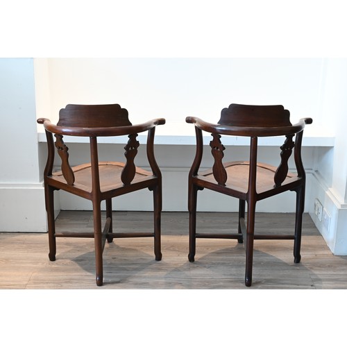 205 - A PAIR OF CHINESE HARDWOOD CORNER CHAIRS, EARLY 20TH CENTURY. A curved top rail on four legs and cro... 