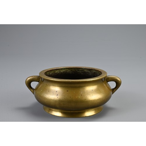 82 - A CHINESE BRONZE CENSER ON STAND, 18/19TH CENTURY. Heavily cast of squat form with twin looped handl... 