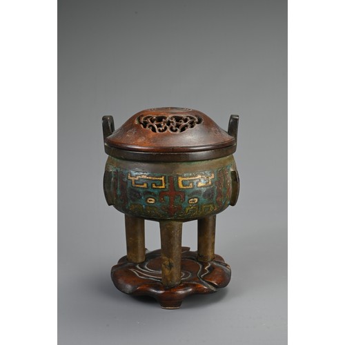 75 - A CHINESE BRONZE ENAMEL CHAMPLEVE TRIPOD CENSER, 19/20TH CENTURY. Circular body with three flanges a... 