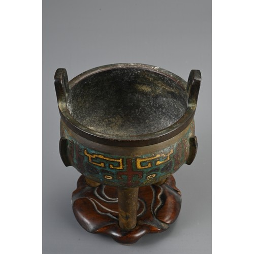 75 - A CHINESE BRONZE ENAMEL CHAMPLEVE TRIPOD CENSER, 19/20TH CENTURY. Circular body with three flanges a... 