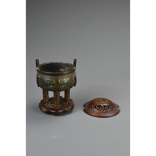 75 - A CHINESE BRONZE ENAMEL CHAMPLEVE TRIPOD CENSER, 19/20TH CENTURY. Circular body with three flanges a... 