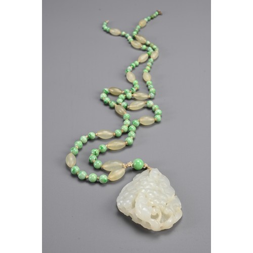 113 - A JADE JADEITE BEADED NECKLACE WITH PENDANTS, 19/20TH CENTURY. Comprising a carved and pierced jadei... 