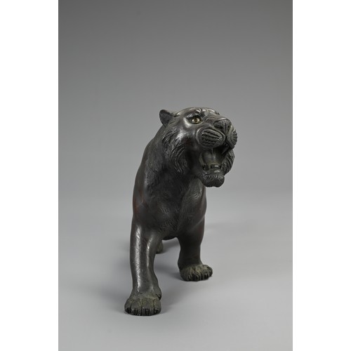 287 - JAPANESE MEIJI PERIOD BRONZE, TIGER OKIMONO BY NYOZAN, late 19th century, with inlaid glass eyes, si... 