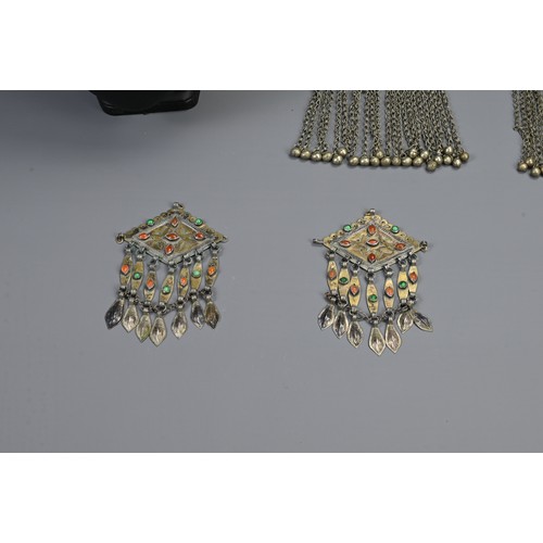 65 - A GROUP OF TURKMAN / INDIAN METAL WARE JEWELLERY ITEMS, 20TH CENTURY. To include a pair of fire gild... 