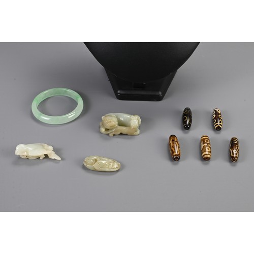 112 - A MIXED GROUP OF CHINESE JADE AND STONE ITEMS. To include a jadeite bangle; A celadon jade lion grou... 