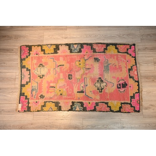 192 - A TIBETAN DRAGON RUG, 19/20TH CENTURY. A rectangular form woven wool rug depicting block type dragon... 