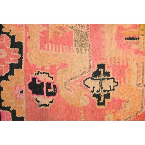 192 - A TIBETAN DRAGON RUG, 19/20TH CENTURY. A rectangular form woven wool rug depicting block type dragon... 