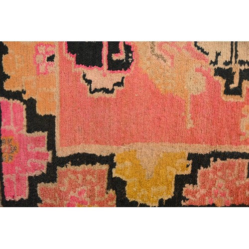 192 - A TIBETAN DRAGON RUG, 19/20TH CENTURY. A rectangular form woven wool rug depicting block type dragon... 