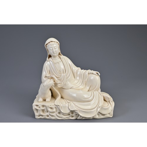 103 - A CHINESE BLANC DE CHINE PORCELAIN FIGURE OF RECLINING GUANYIN, AFTER HE CHAOZONG, QING DYNASTY. The... 