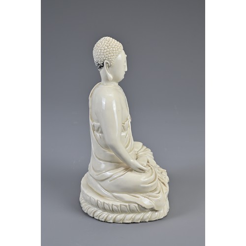 104 - A CHINESE DEHUA PORCELAIN FIGURE OF BUDDHA, LATE MING DYNASTY. The figure dressed in robes seated on... 