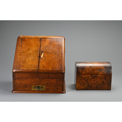 355 - AN EDWARDIAN WALNUT STATIONARY BOX AND A 19TH CENTURY DOMED RECTANGULAR TEA CADDY. The hinged statio... 