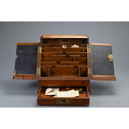 355 - AN EDWARDIAN WALNUT STATIONARY BOX AND A 19TH CENTURY DOMED RECTANGULAR TEA CADDY. The hinged statio... 