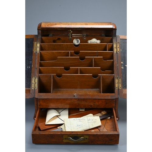 355 - AN EDWARDIAN WALNUT STATIONARY BOX AND A 19TH CENTURY DOMED RECTANGULAR TEA CADDY. The hinged statio... 