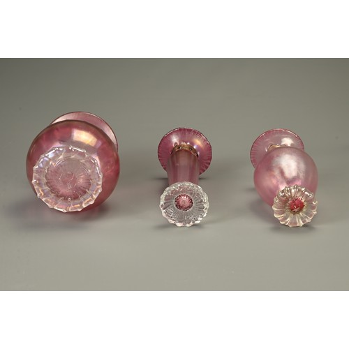 352 - THREE ART GLASS VASES BY ANTHONY STERN. Each with etched signature to base, with pink lustred bodies... 