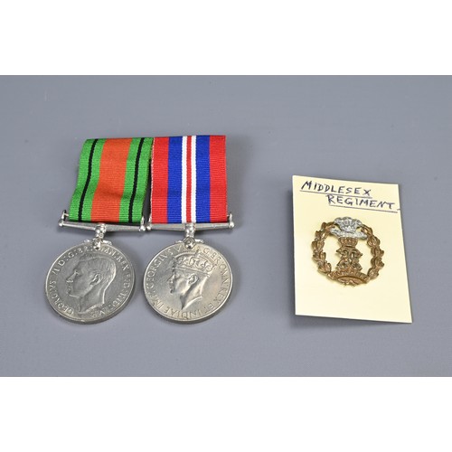 342 - TWO GEORGE VI II WORLD WAR MEDALS, A MIDDLESEX REGIMENT CAP AND BADGE AND A COLLAR BADGE, TOGETHER W... 